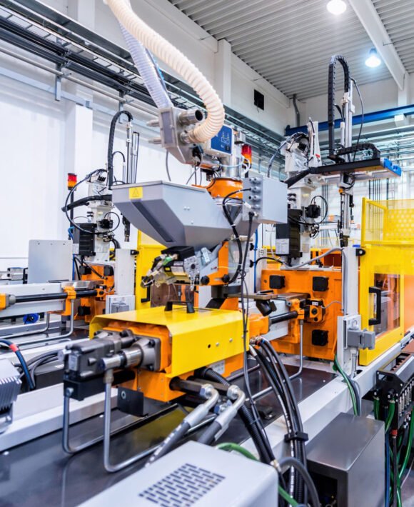 istockphoto-510162486-2048x2048 Horizontal color image of large group of automated injection moulding machines for plastic parts production.
